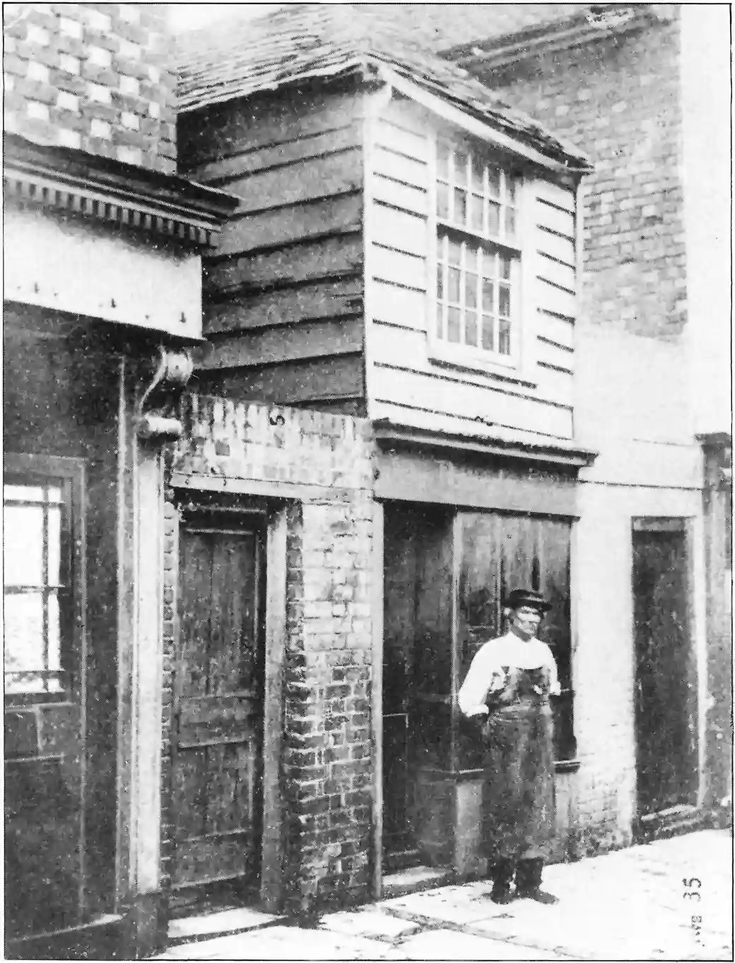 Unknown man photographed outside John Pounds workshop